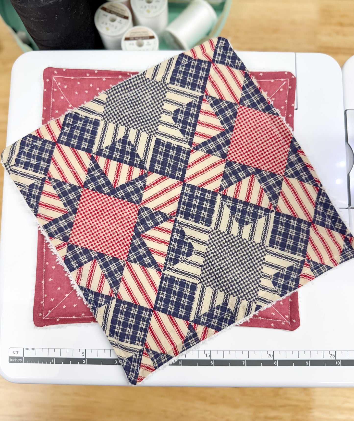 Quilted fabric with star pattern on a cutting mat