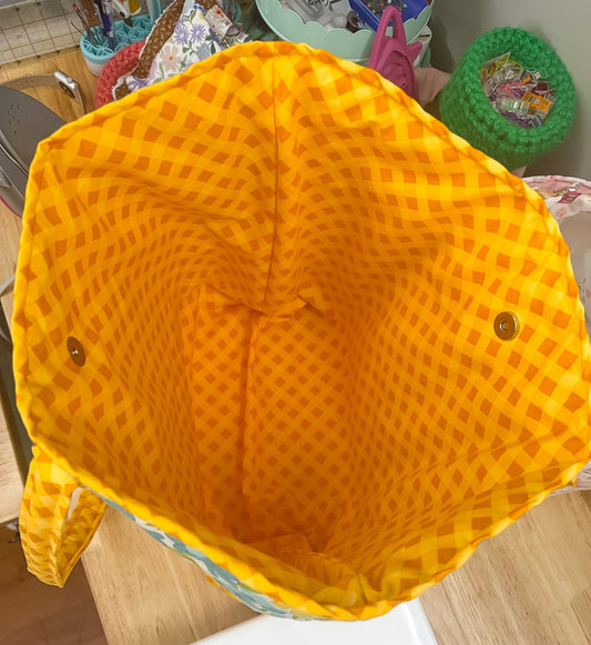Yellow mesh bag on a wooden surface with a kitchen background