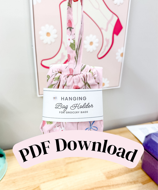 A pink floral hanging bag holder made of fabric, shown with a paper label that reads 'Hanging Bag Holder for Grocery Bags.' A large overlaid banner says 'PDF Download.