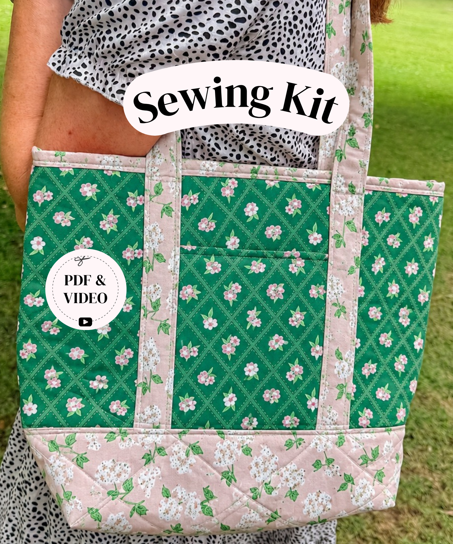 A person outdoors holding a quilted tote bag made from green floral fabric with pink trim. The bag has a front pocket and a white 'Sewing Kit' label overlay, with a circular 'PDF & VIDEO' badge on the left.