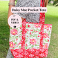 Person holding a floral tote bag with text overlay about 'Daisy Mae Pocket Tote' and resources.