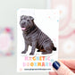 Magnetic bookmark with a dog design held by a hand against a colorful background