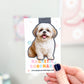Magnetic bookmark with a dog illustration held by a hand against a blurred background