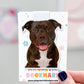 Dog-shaped bookmark held by a hand with a blurred background