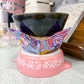 Pink ceramic product with colorful butterfly design on a kitchen counter