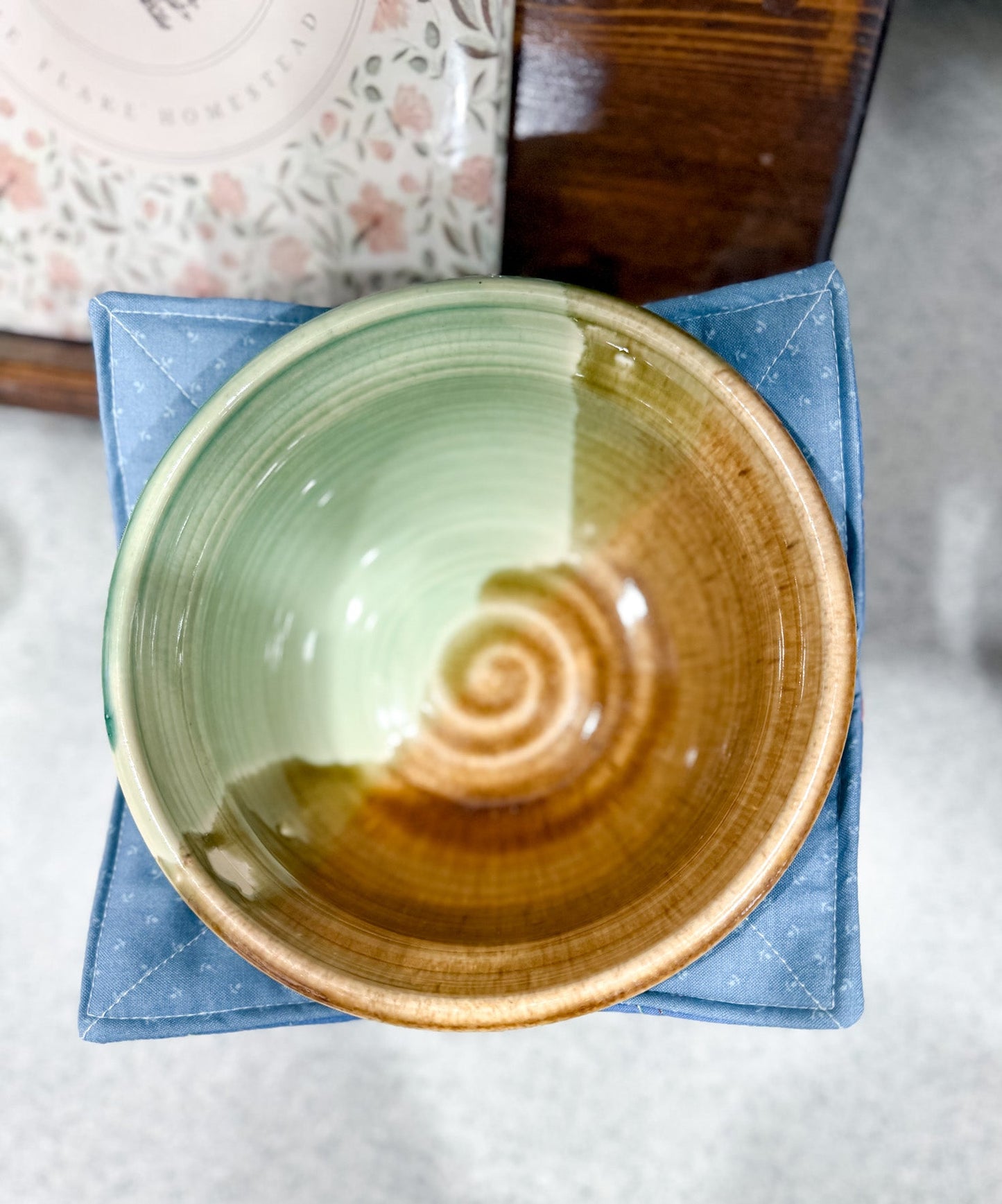 Ceramic bowl with a spiral design on a blue napkin