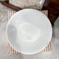 White ceramic bowl on a patterned napkin with a blurred background