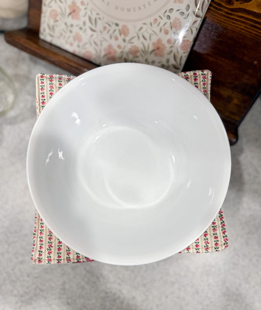 White ceramic bowl on a patterned napkin with a blurred background