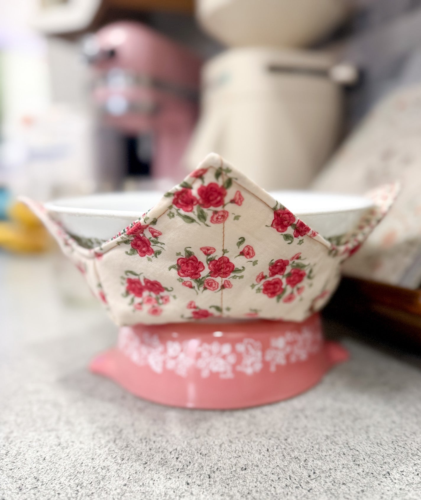 Small pink and floral-patterned container on a gray surface