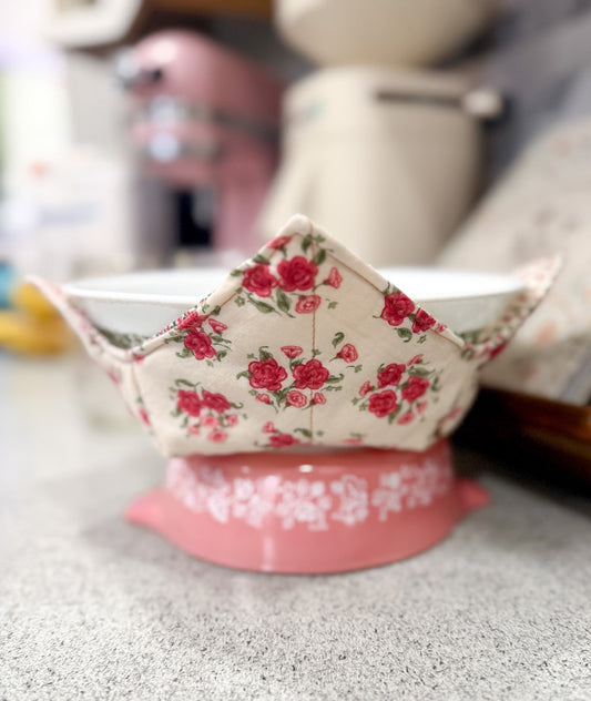 Small pink and floral-patterned container on a gray surface