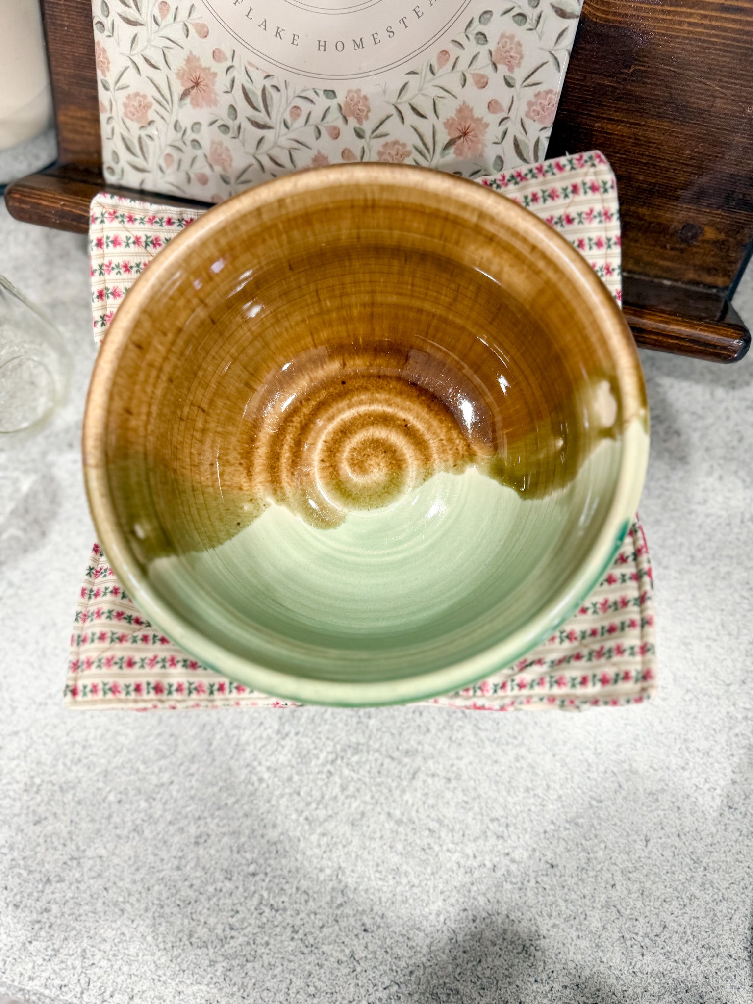 Ceramic bowl with a spiral design on a textured surface
