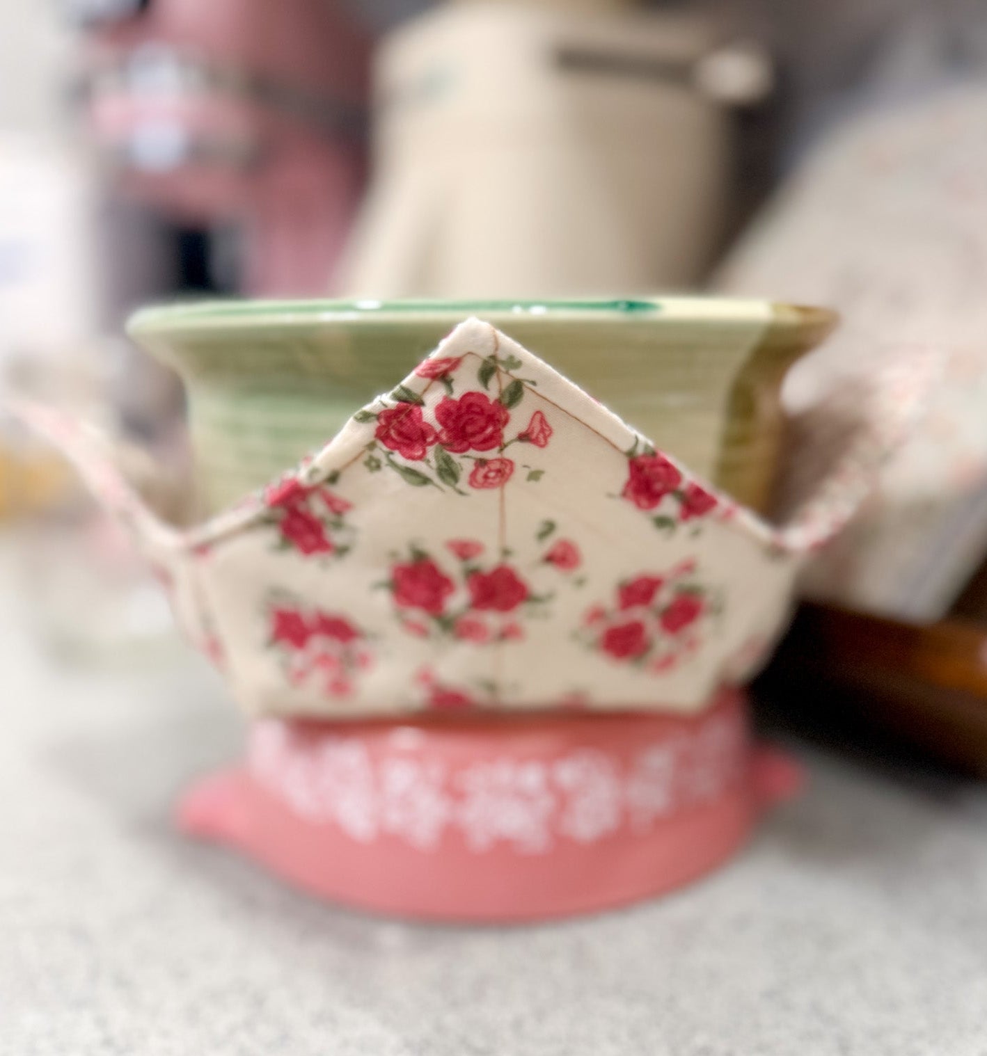 Decorative ceramic bowl with floral design on a speckled countertop
