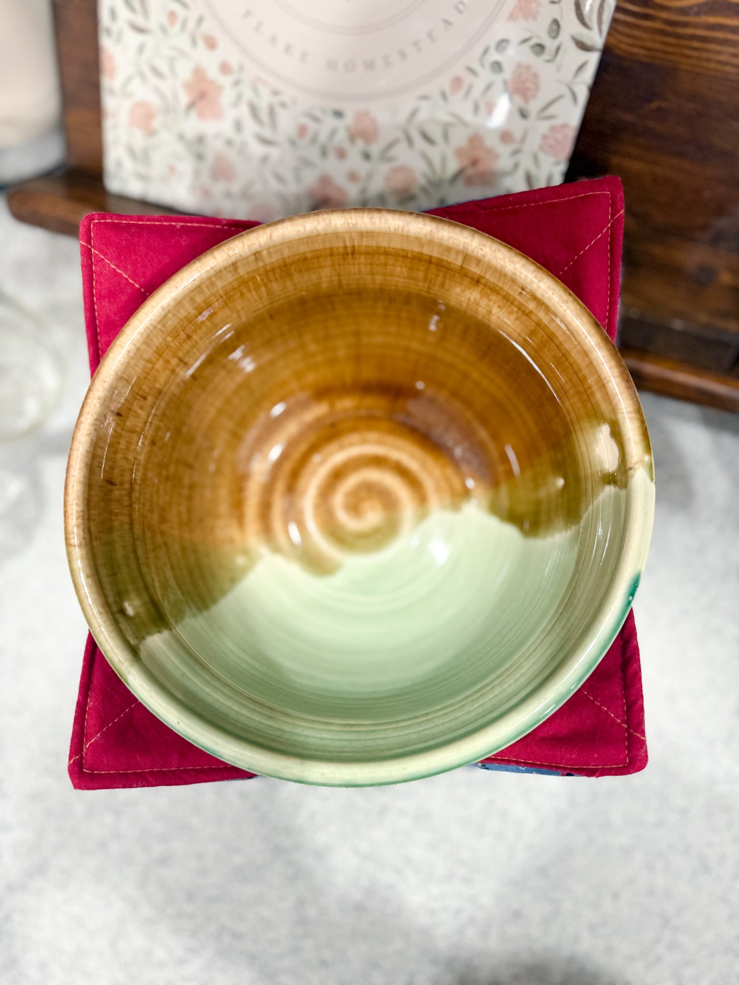 Ceramic bowl with a spiral design on a red napkin