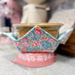 Decorative ceramic bowl with floral fabric cover on a countertop