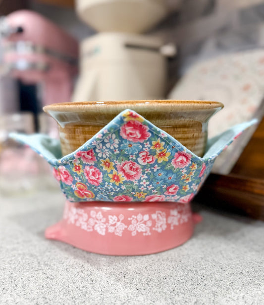 Decorative ceramic bowl with floral fabric cover on a countertop