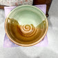 Ceramic bowl with a spiral design on a gray surface