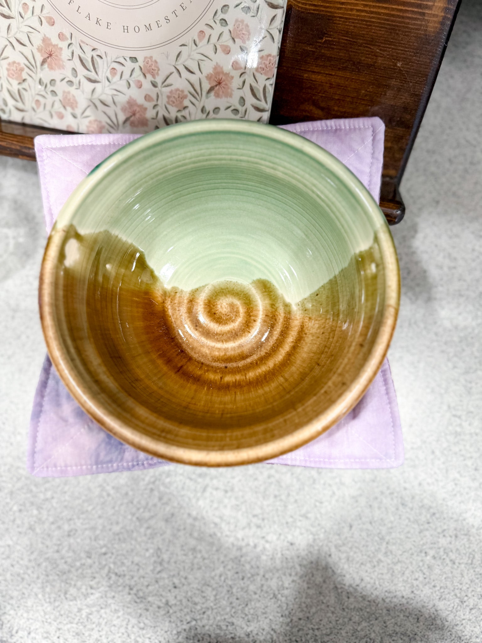 Ceramic bowl with a spiral design on a gray surface