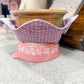 Pink and floral-patterned container on a kitchen counter