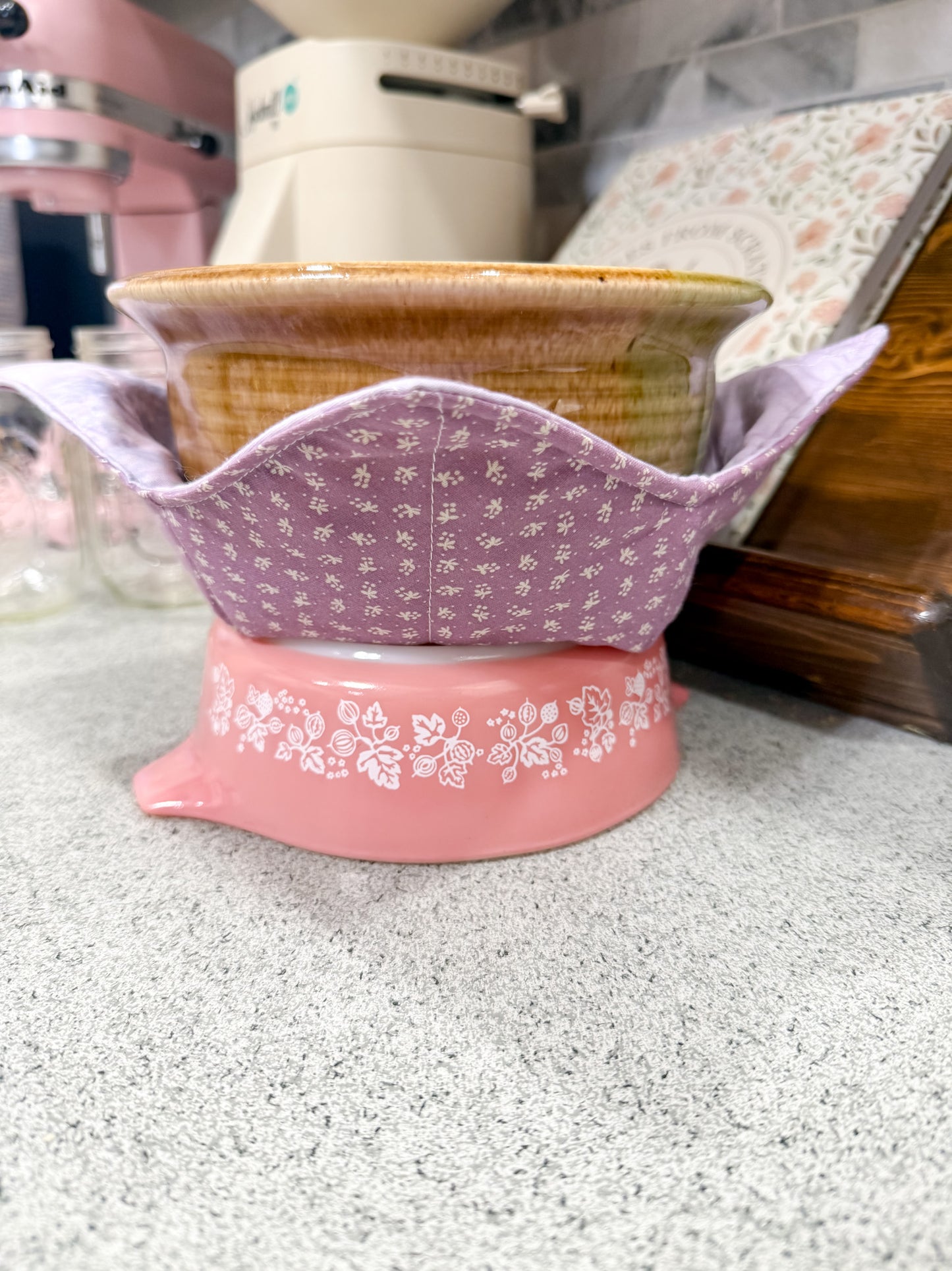 Pink and floral-patterned container on a kitchen counter
