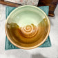 Ceramic bowl with a gradient design on a textured surface