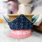 Ceramic pot with blue floral design on a pink base