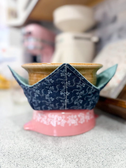 Ceramic pot with blue floral design on a pink base