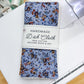 Pack of handmade dish cloths with floral pattern on a cutting board.