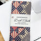 Handmade dish cloth with patchwork pattern on a white surface