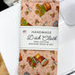 Handmade dish cloth packaging with a pattern on a white surface