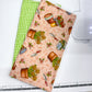 Two fabric swatches on a cutting mat with a ruler, one green checkered and one with rustic patterns.