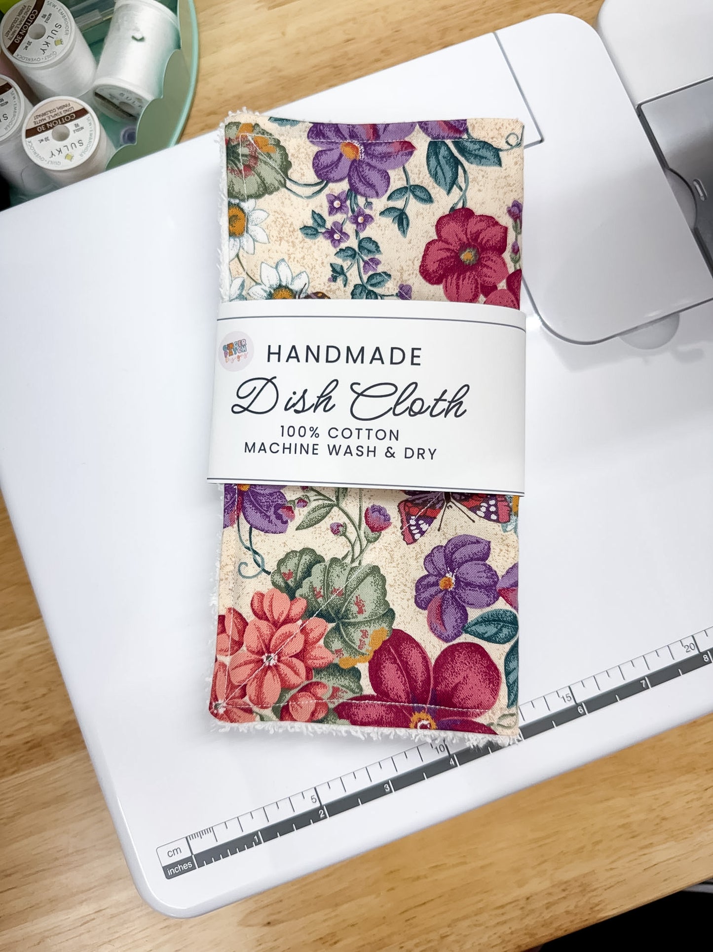 Handmade dish cloth packaging with floral design on a sewing machine