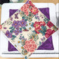 Floral fabric on a cutting mat with a ruler, on a wooden surface.