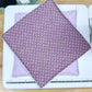 Purple fabric with white patterns on a sewing machine