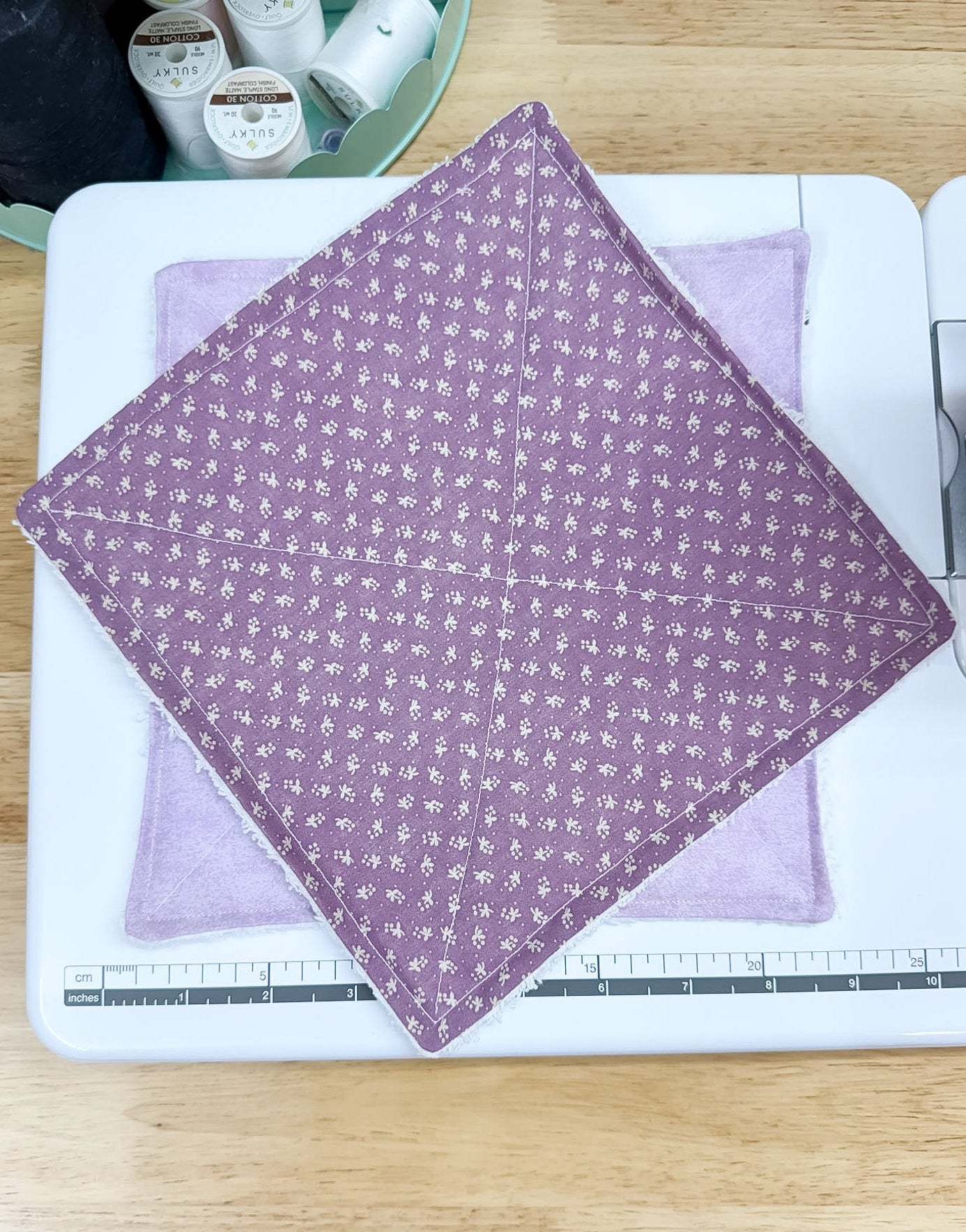 Purple fabric with white patterns on a sewing machine