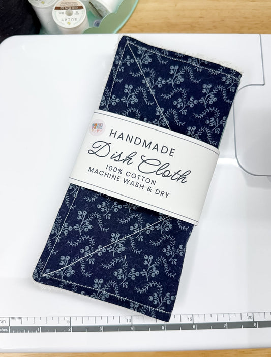Handmade dish cloth with floral pattern on a white cutting mat