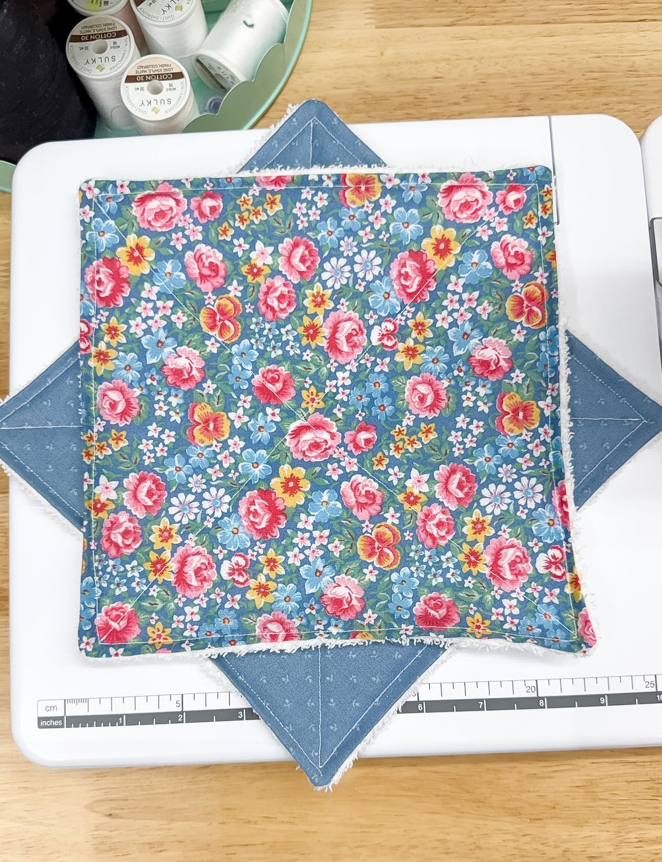 Floral fabric on a cutting mat with a ruler