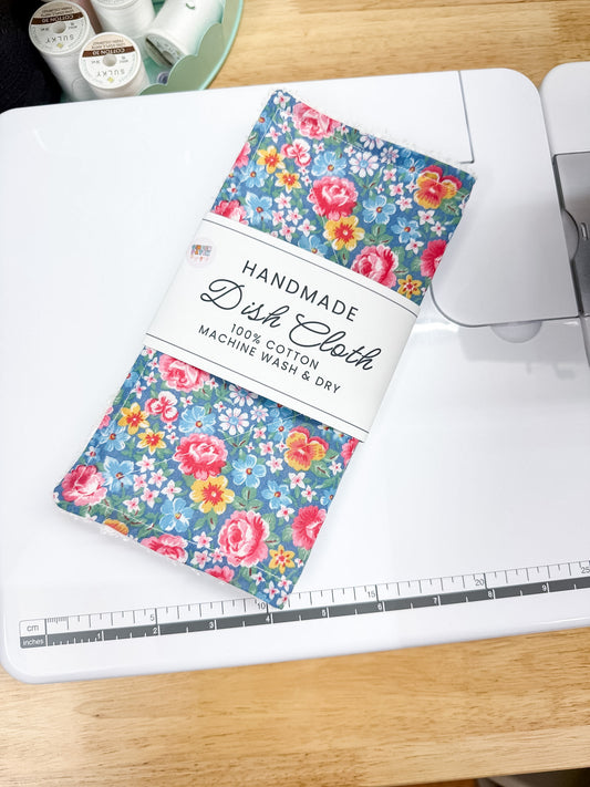 Handmade dish cloth with floral pattern on a cutting mat