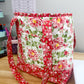 Floral fabric bag on a wooden surface with a printer in the background
