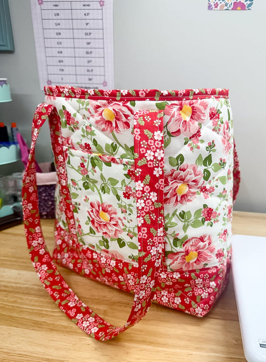 Floral fabric bag on a wooden surface with a printer in the background