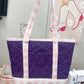 Purple and pink tote bag with glittery texture on a sewing machine table.