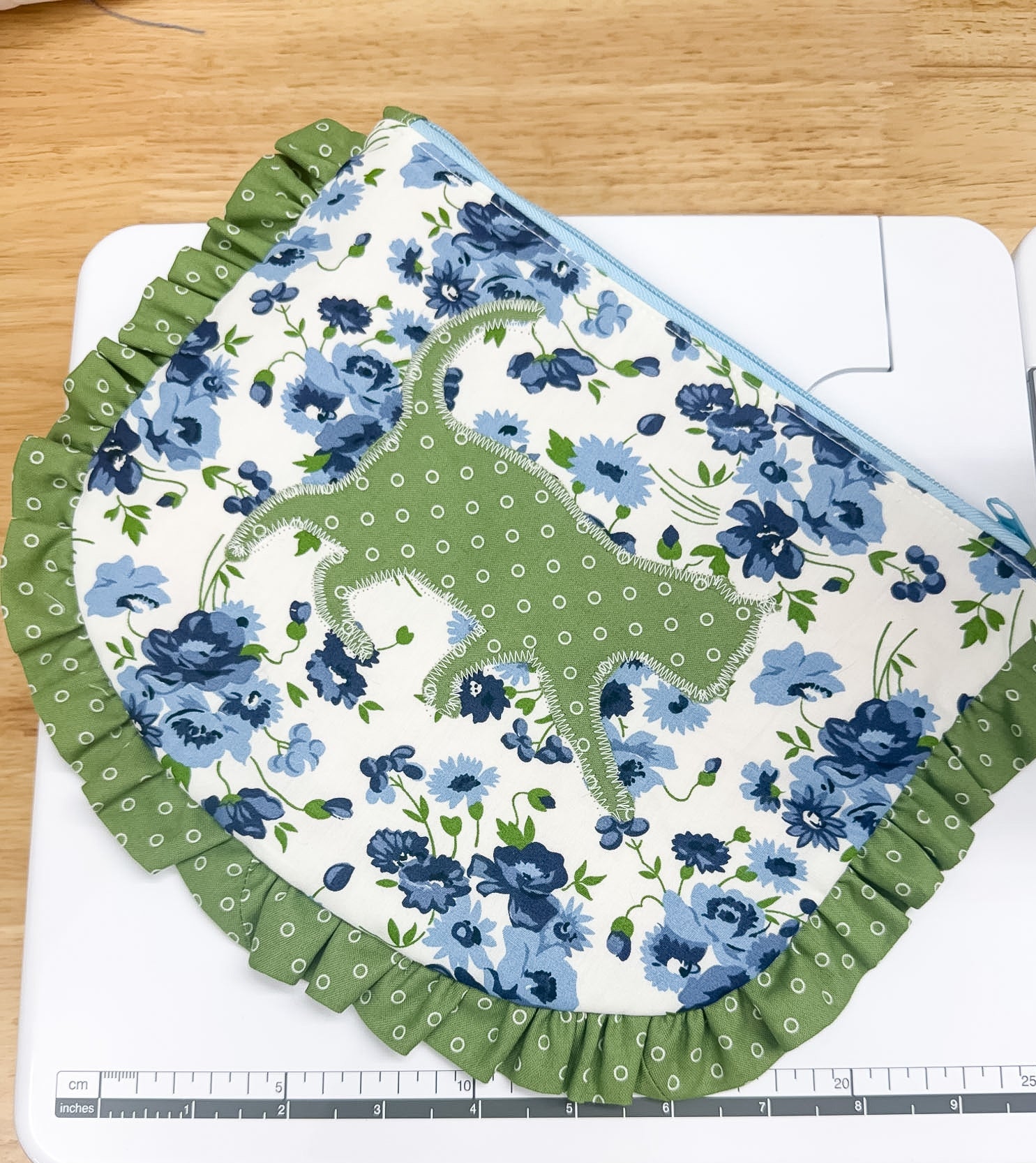 Floral fabric with green border on a cutting mat with ruler