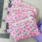 Set of pink fabric pouches with strawberry pattern on a cutting mat