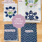 Fabric pieces with labels on a wooden surface, featuring patterns and text about fabric types.