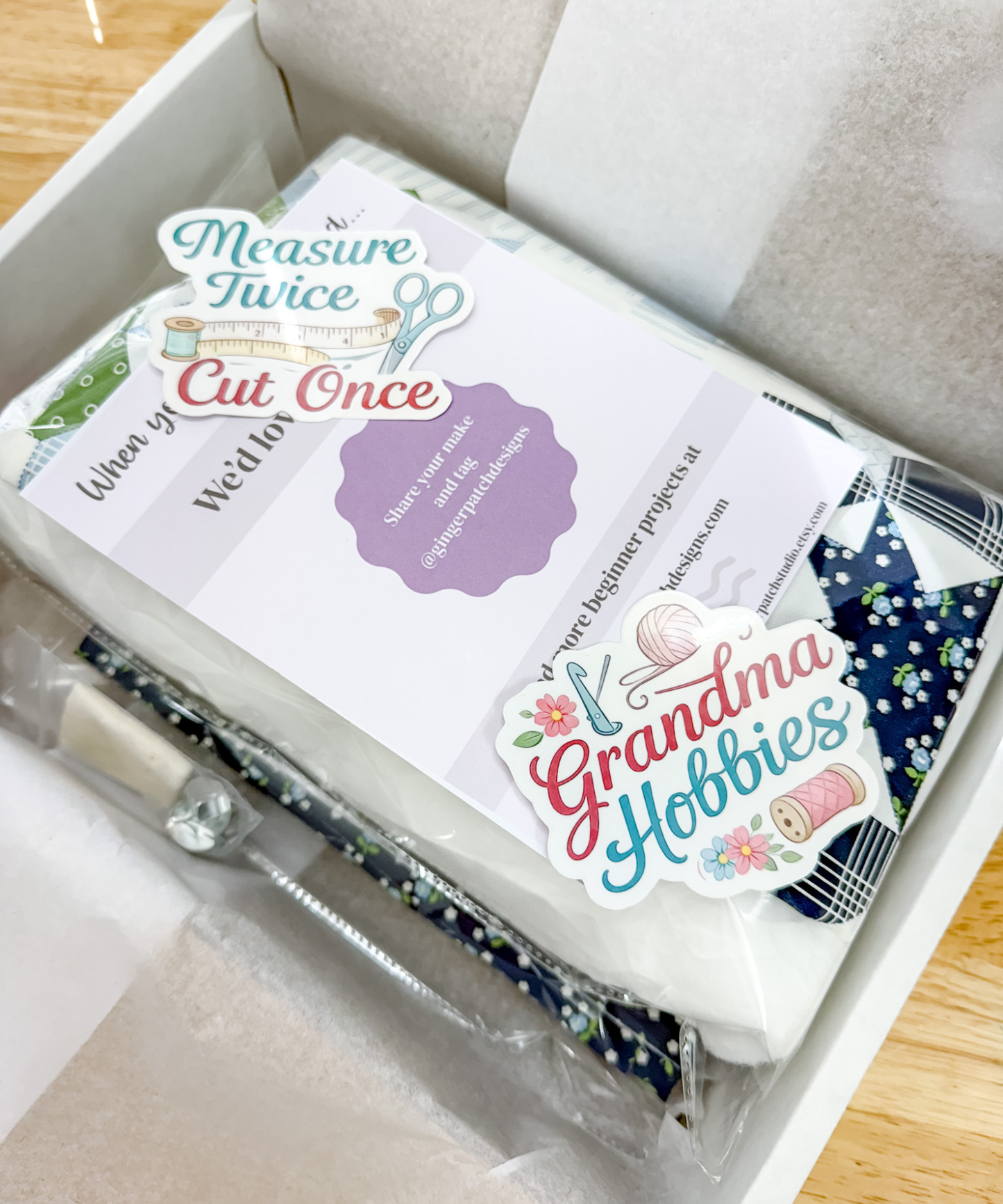 Packaging of Grandma Hobbies craft kit with scissors and materials on a wooden surface.